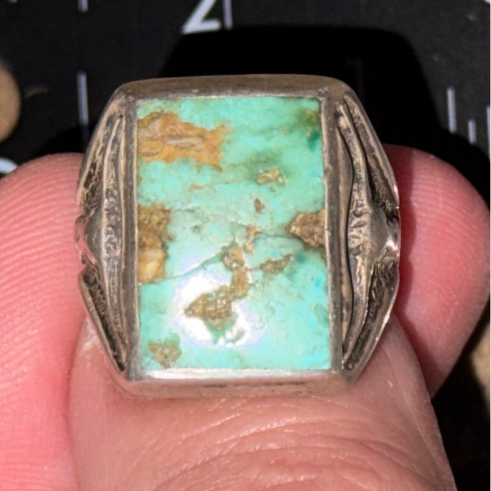 This is a Royston Mine turquoise silver men's ring with longhorn engraving.